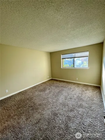 an empty room with a empty space and window