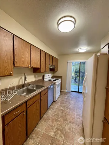 a kitchen with a sink stove and refrigerator