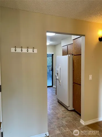 a view of a hallway with a refrigerator