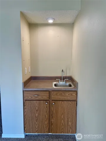 a bathroom with a granite countertop sink a toilet and mirror