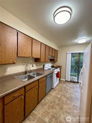 a kitchen with a sink stove and cabinets