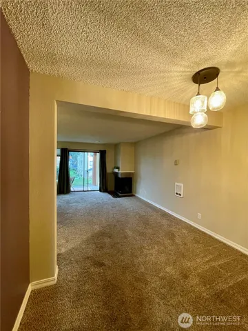 a view of empty room with a fireplace