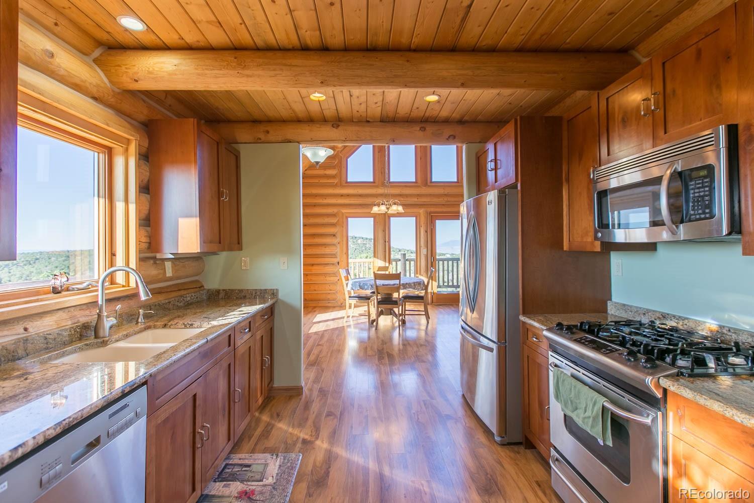 18342 Miller Canyon Ranch Road Glade Park, CO 81523 - Photo 12 of 38 a kitchen with stove and wooden cabinets