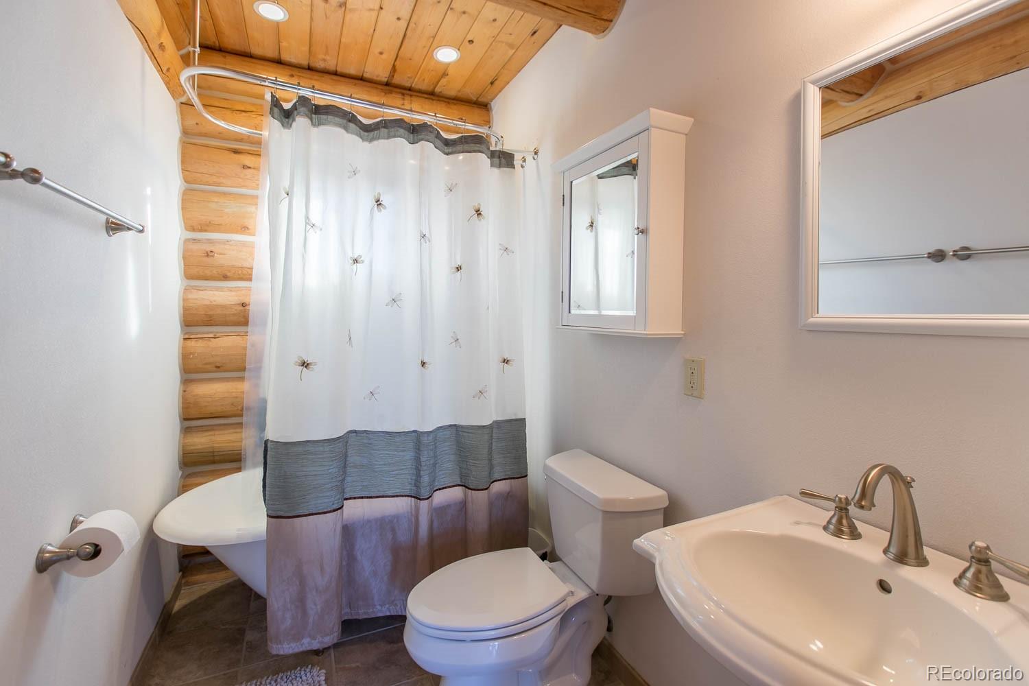 18342 Miller Canyon Ranch Road Glade Park, CO 81523 - Photo 16 of 38 a bathroom with a sink a toilet a mirror and shower