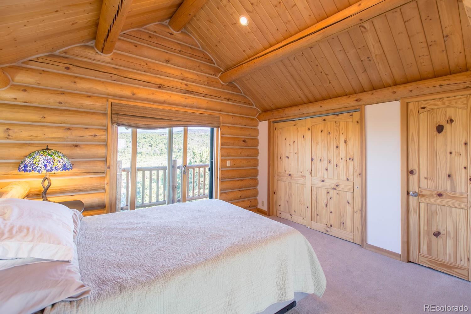 18342 Miller Canyon Ranch Road Glade Park, CO 81523 - Photo 17 of 38 a bedroom with a bed and a large window