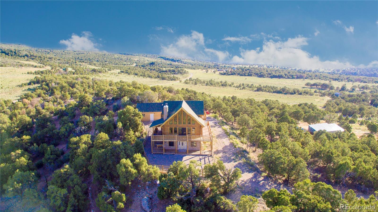 18342 Miller Canyon Ranch Road Glade Park, CO 81523 - Photo 2 of 38 a view of a lake with a mountain in the background