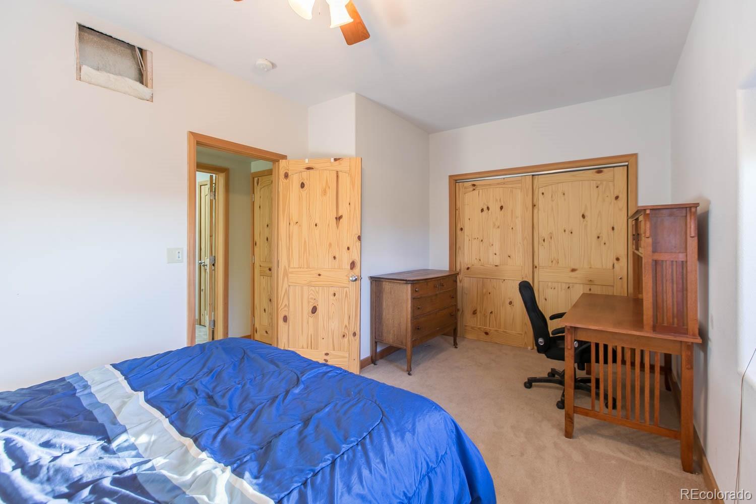 18342 Miller Canyon Ranch Road Glade Park, CO 81523 - Photo 26 of 38 a bedroom with a bed and a table