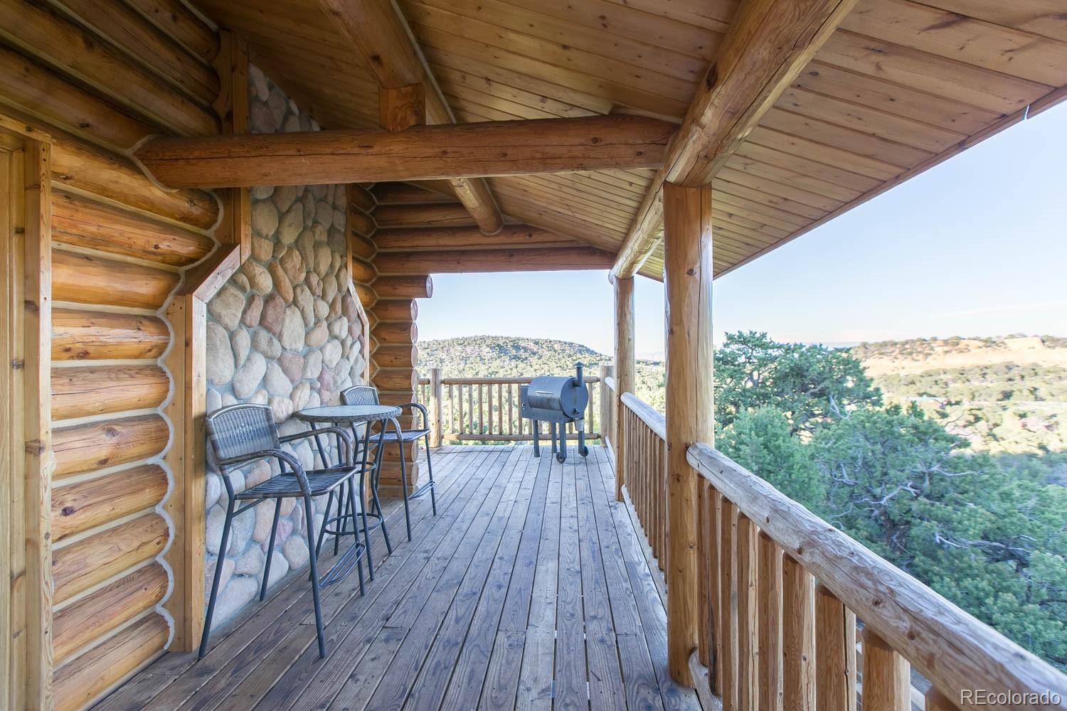 18342 Miller Canyon Ranch Road Glade Park, CO 81523 - Photo 28 of 38 a view of a balcony with chairs and wooden floor