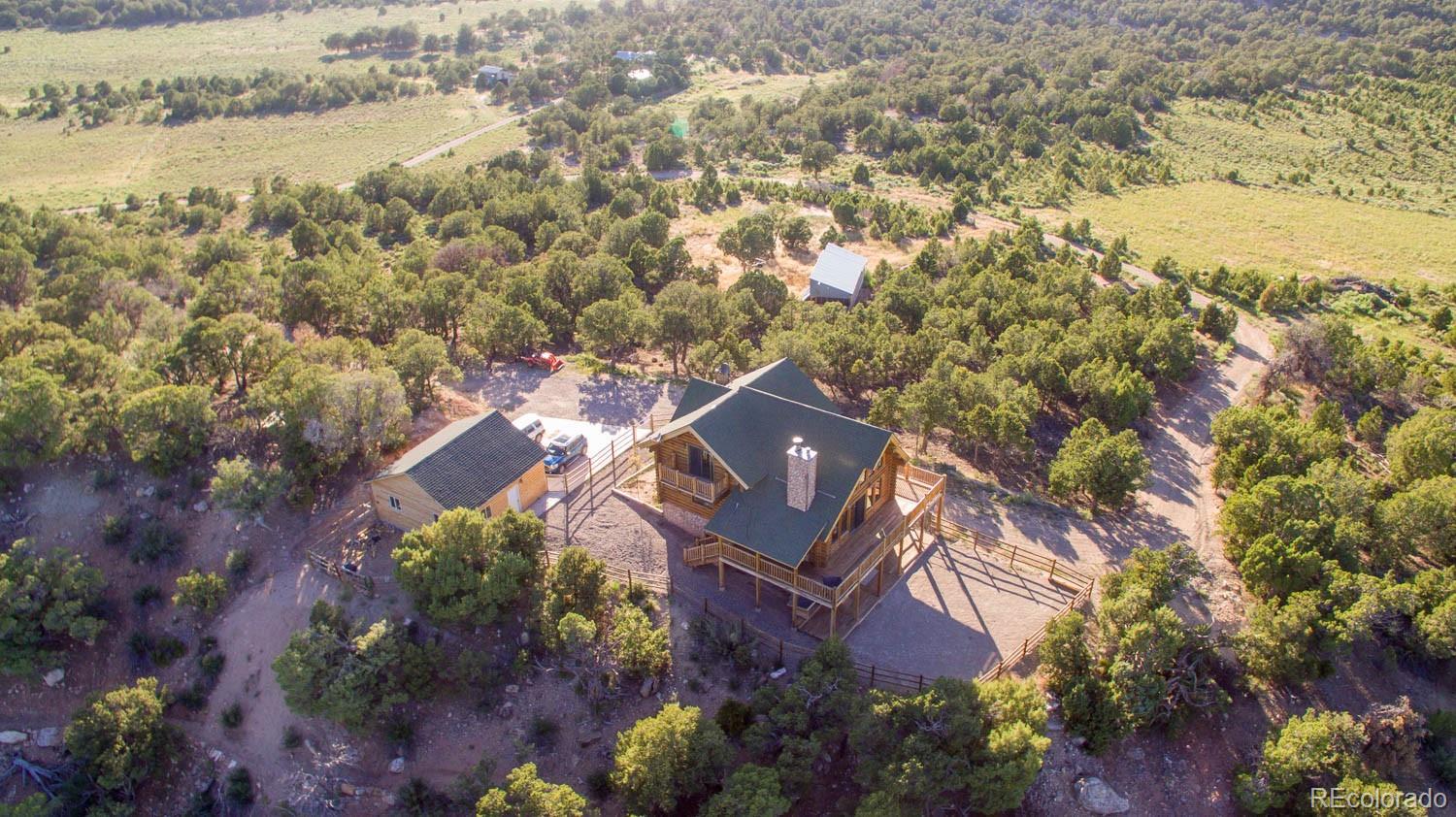 18342 Miller Canyon Ranch Road Glade Park, CO 81523 - Photo 3 of 38 an aerial view of a house with a lake