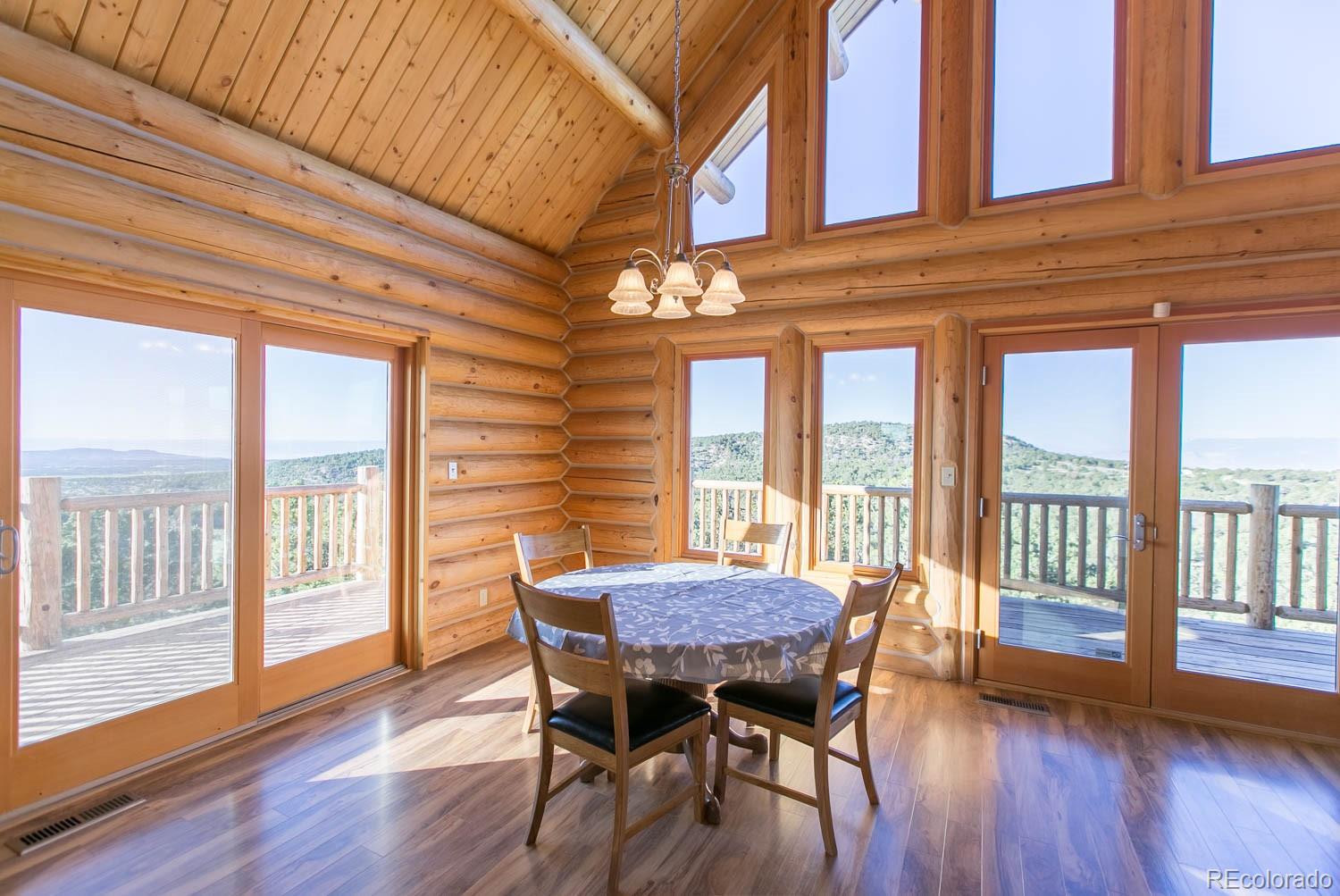 18342 Miller Canyon Ranch Road Glade Park, CO 81523 - Photo 8 of 38 a view of a dining room with furniture window and wooden floor