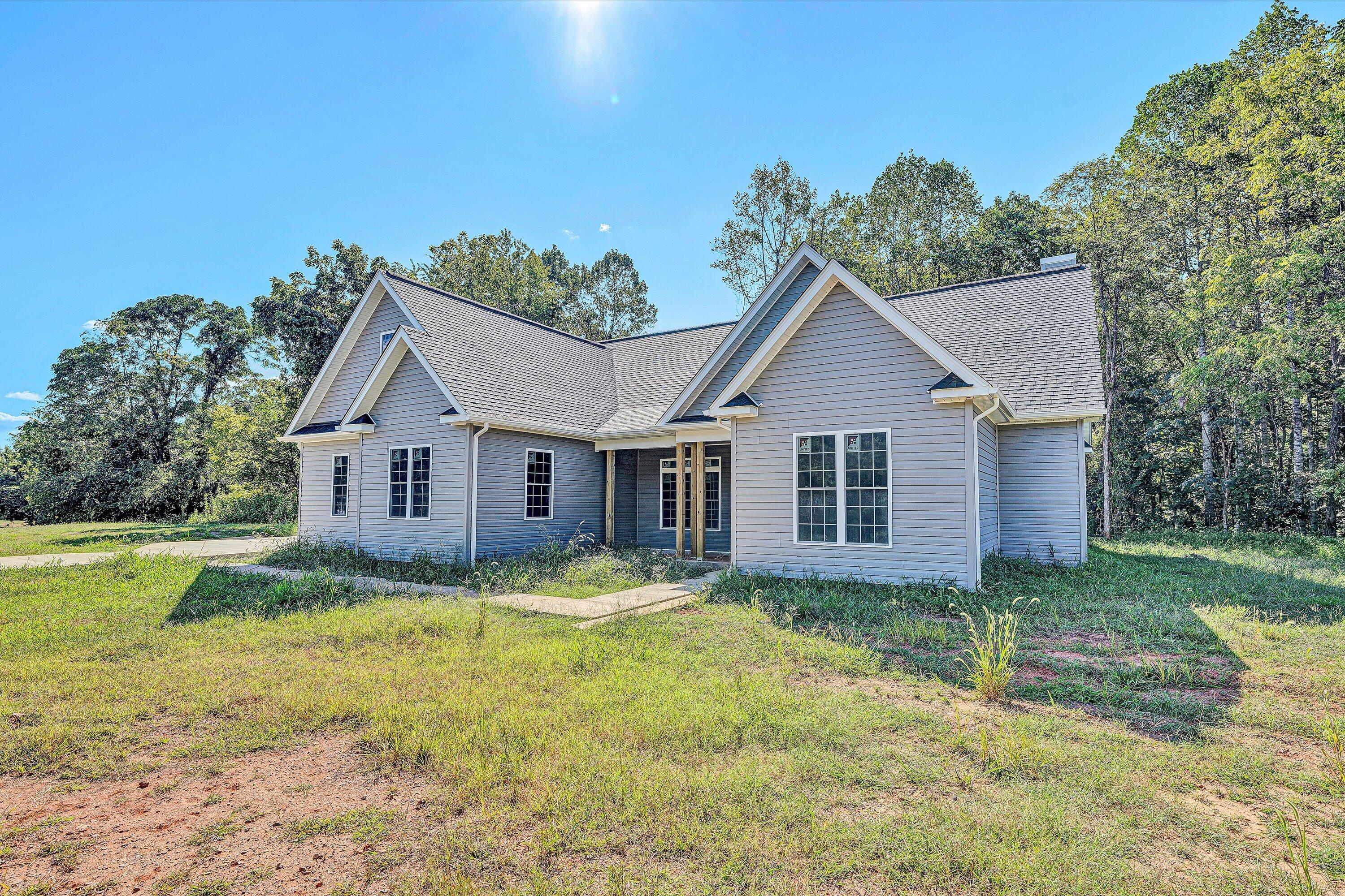 3769 Hales Ford Road Moneta, VA 24121 - Photo 2 of 26 a view of a yard in front of a house with large trees