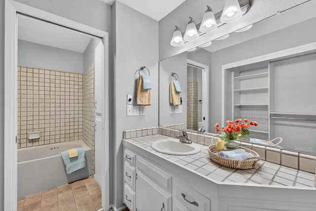 a bedroom with a bed and a painting on the wall