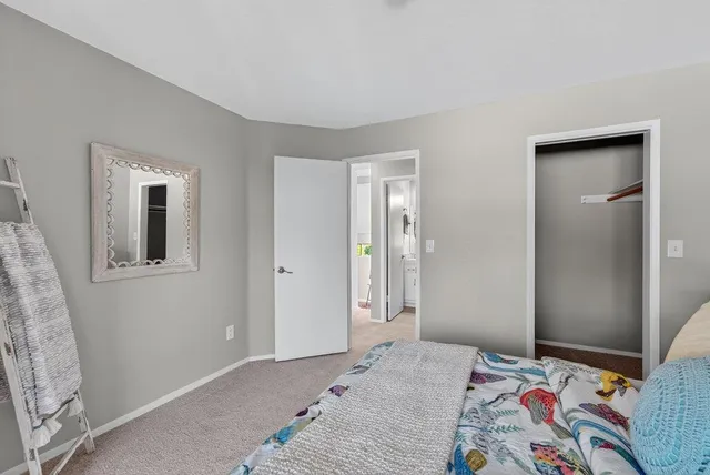 a bedroom with a bed and a painting on the wall