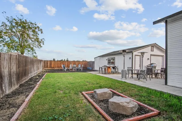 a view of a backyard with sitting area