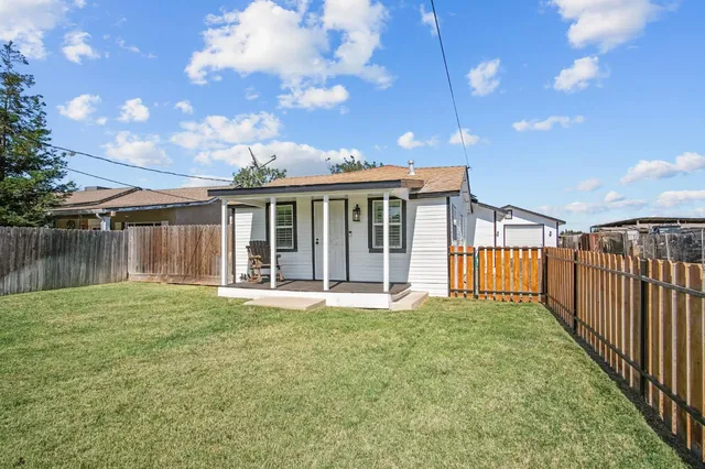 a view of a house with a yard and deck