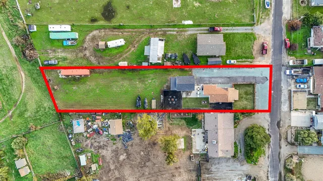 a view of a house with wooden fence