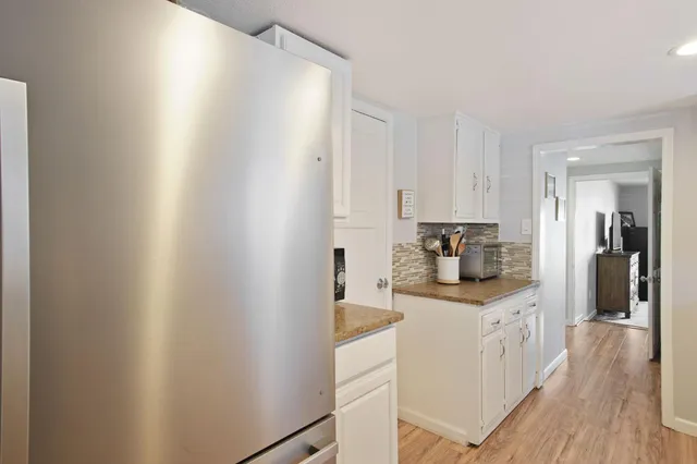 a kitchen with stainless steel appliances a sink and cabinets