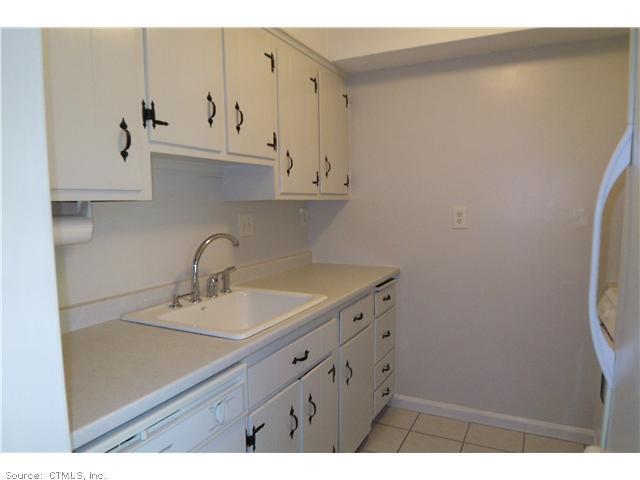 9 Spring Street, Unit 9 Wethersfield, CT 06109 - Photo 1 of 1 a bathroom with a sink and a mirror
