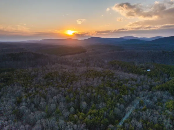 a view of mountain and grassy field