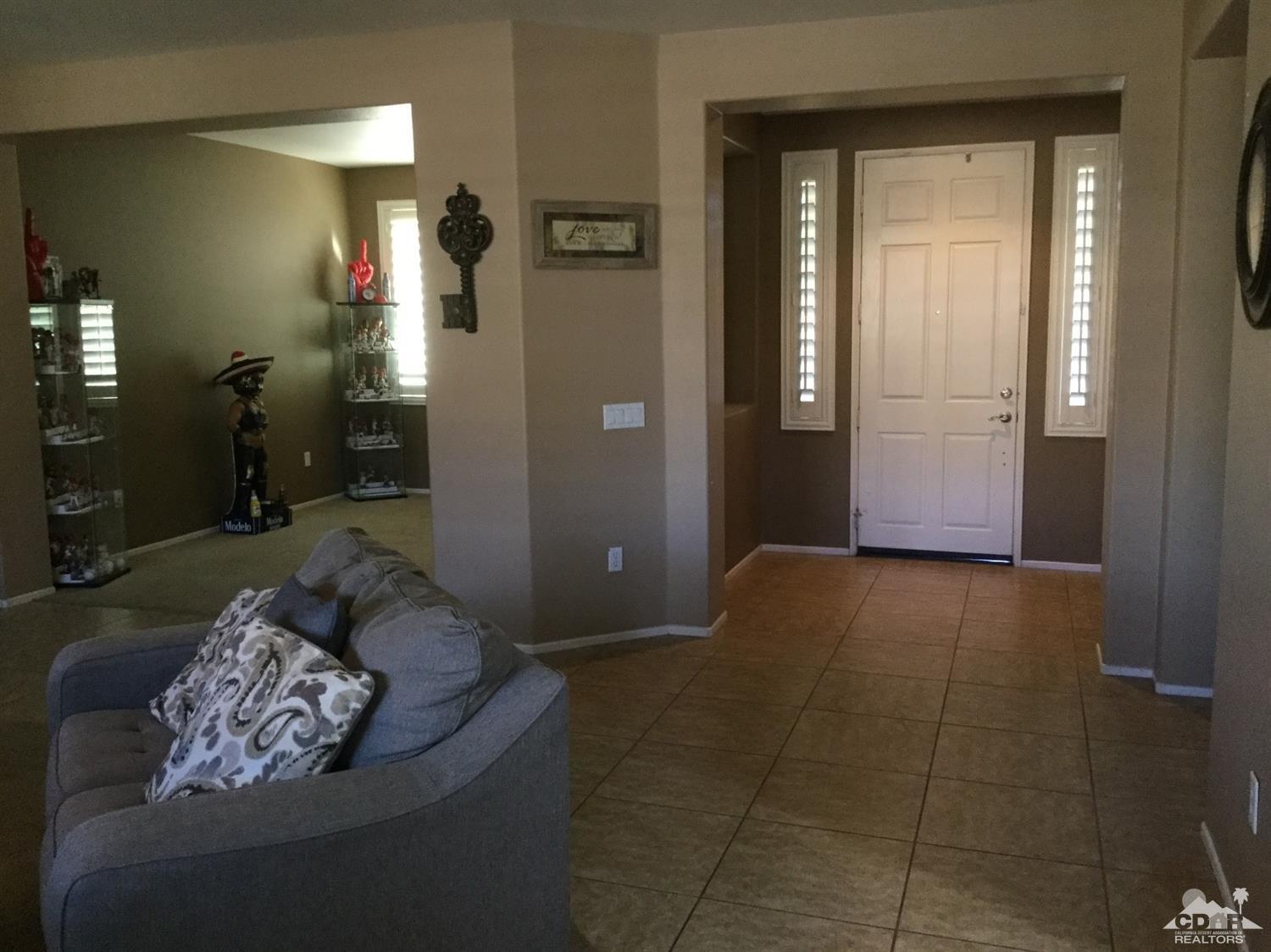 83316 Lone Star Road Indio, CA 92203 - Photo 11 of 43 a living room with furniture and a rug