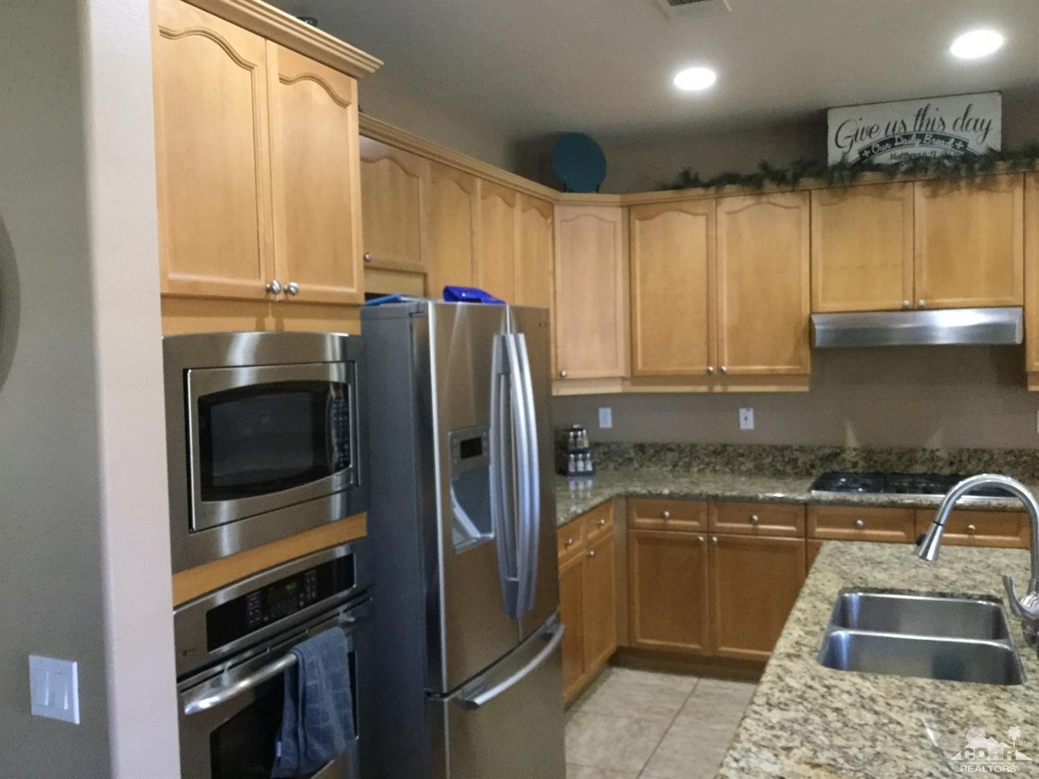 83316 Lone Star Road Indio, CA 92203 - Photo 3 of 43 a kitchen with a refrigerator sink and stove