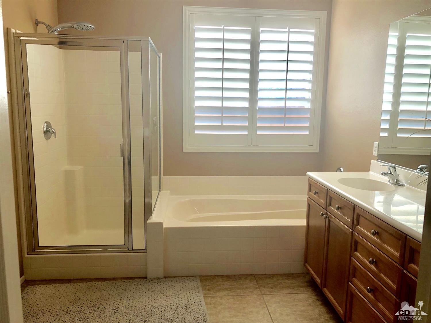 83316 Lone Star Road Indio, CA 92203 - Photo 21 of 43 a bathroom with a tub sink and mirror