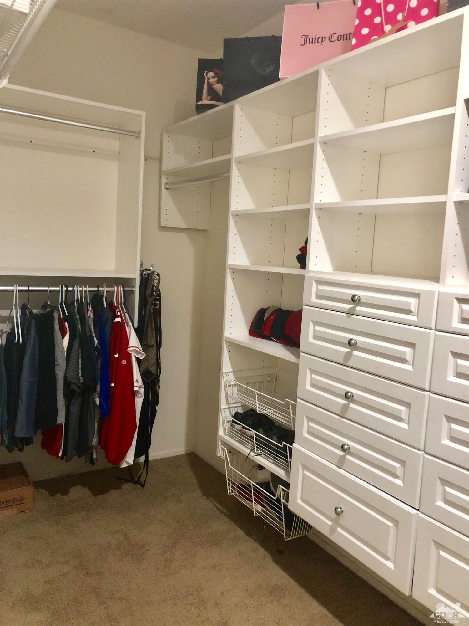 83316 Lone Star Road Indio, CA 92203 - Photo 23 of 43 a view of walk in closet with clothes and shoes