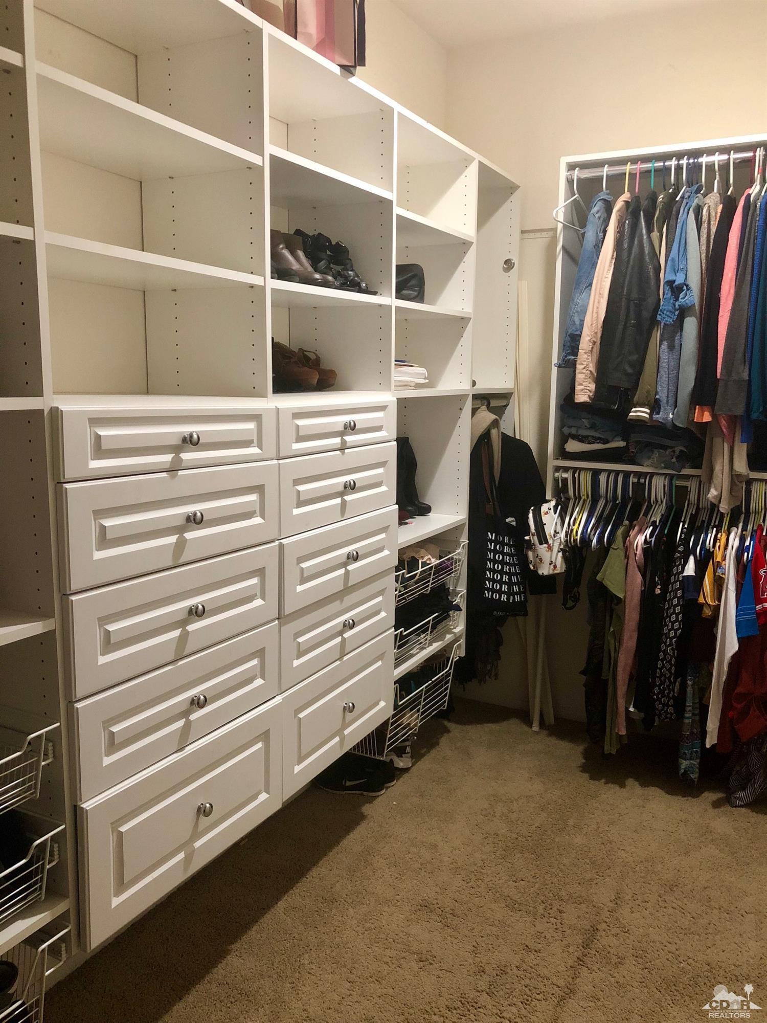 83316 Lone Star Road Indio, CA 92203 - Photo 24 of 43 a view of walk in closet with clothes and shoes