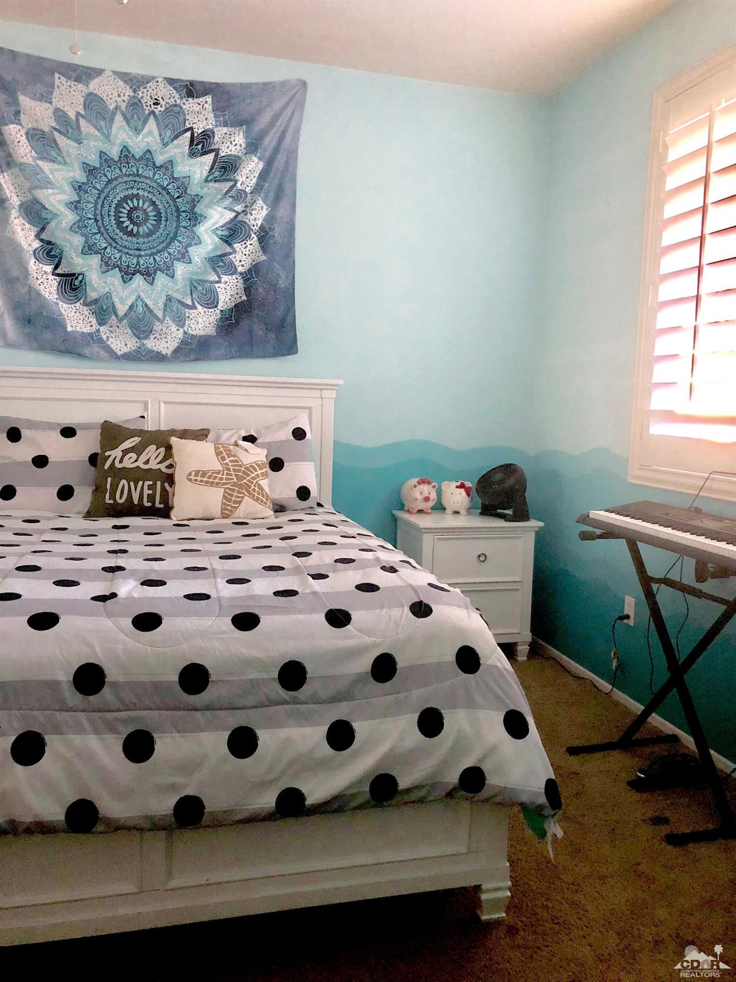 83316 Lone Star Road Indio, CA 92203 - Photo 27 of 43 a bedroom with a bed and a chair