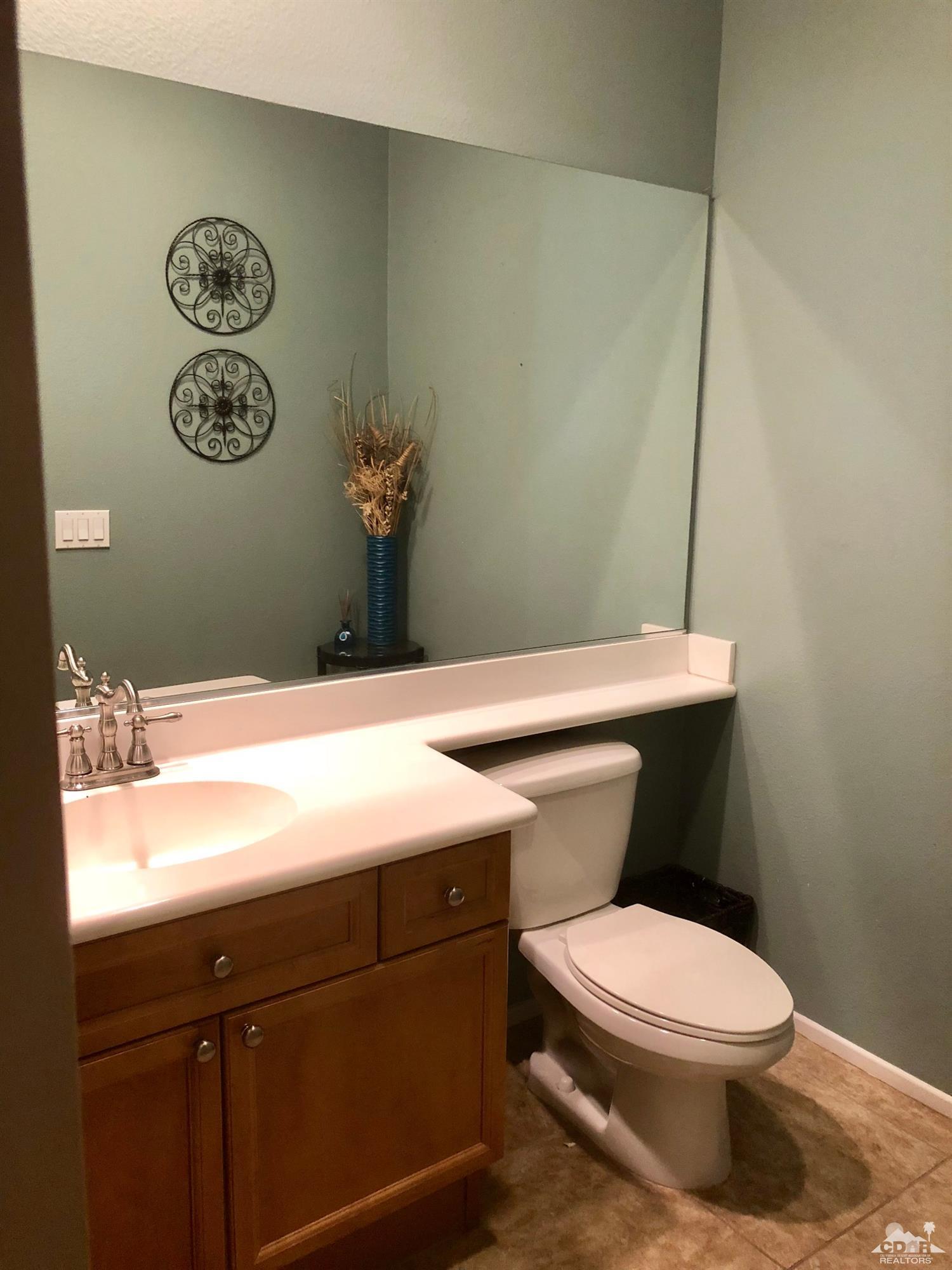83316 Lone Star Road Indio, CA 92203 - Photo 28 of 43 a bathroom with a toilet a sink and a shower