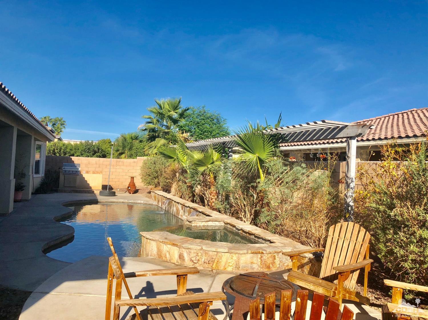 83316 Lone Star Road Indio, CA 92203 - Photo 32 of 43 a view of a swimming pool with seating area