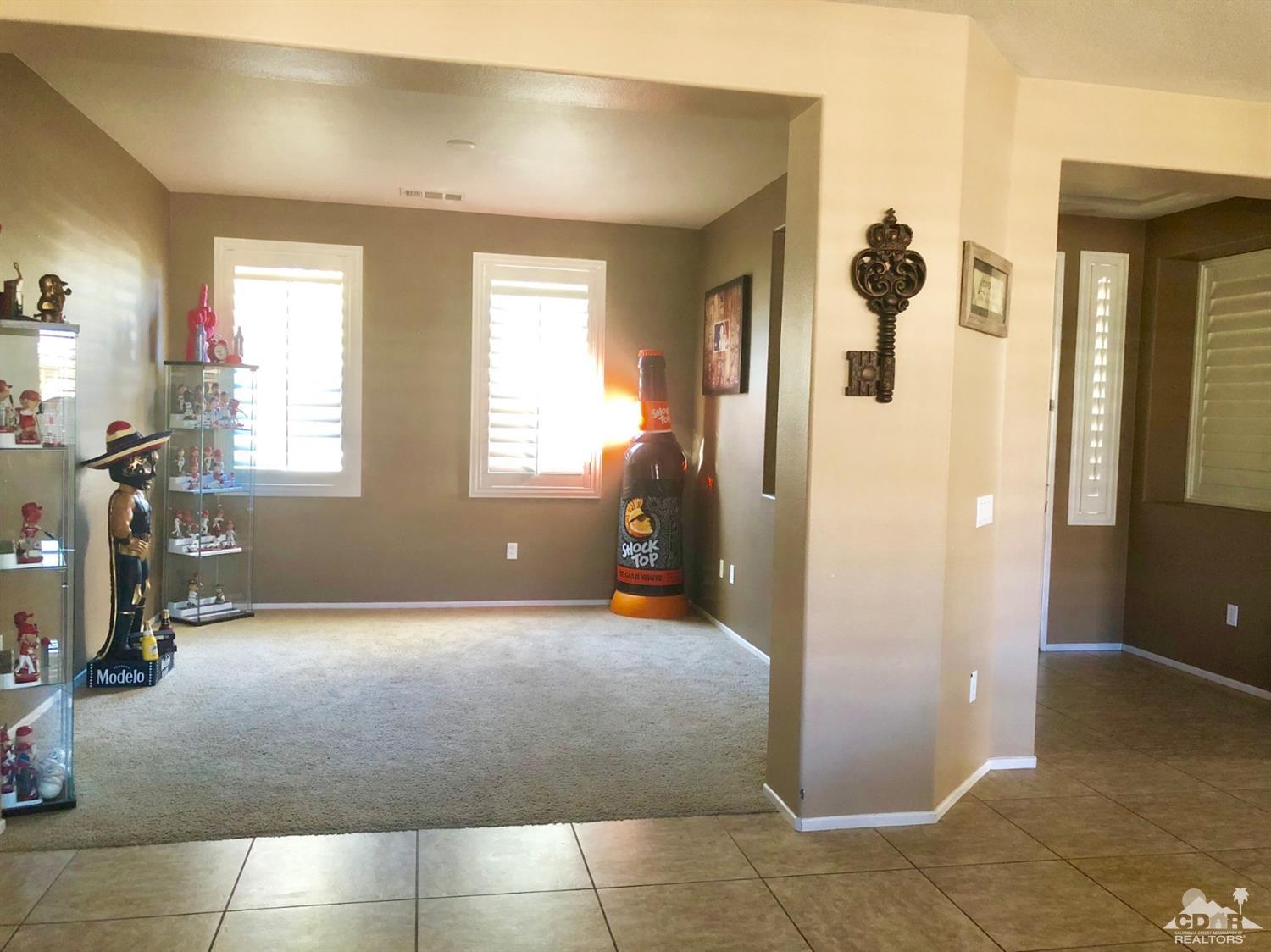 83316 Lone Star Road Indio, CA 92203 - Photo 36 of 43 a view of a livingroom with furniture and windows
