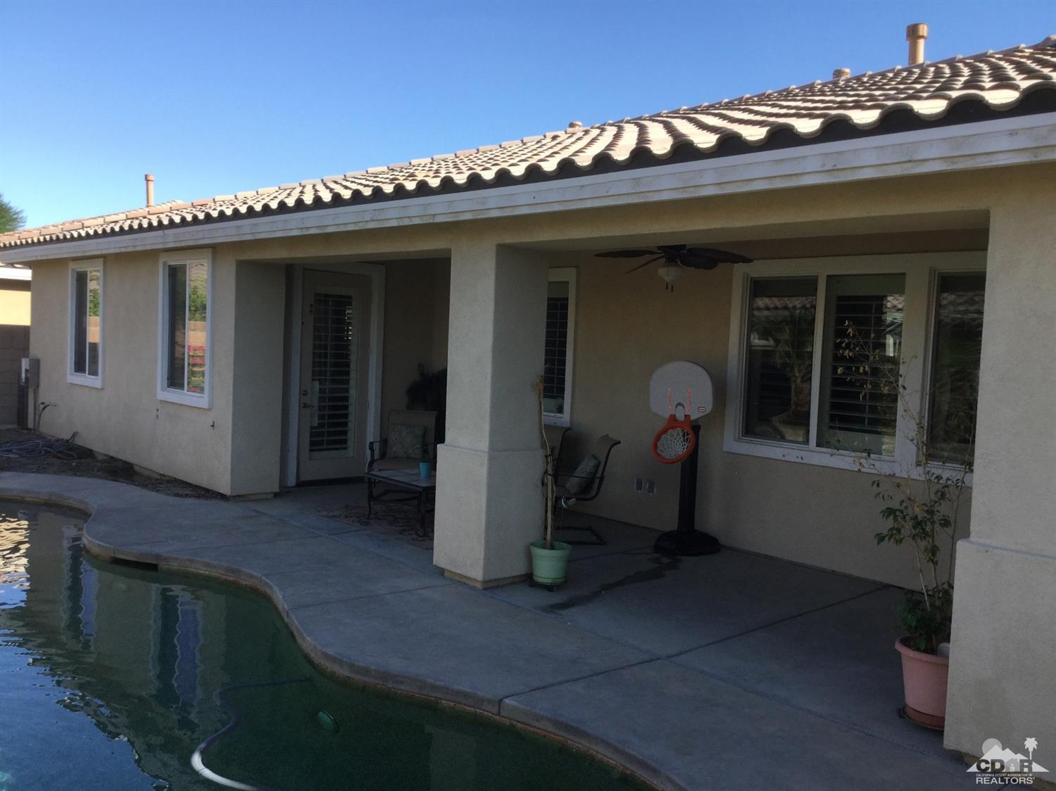 83316 Lone Star Road Indio, CA 92203 - Photo 41 of 43 a front view of a house with a sitting area