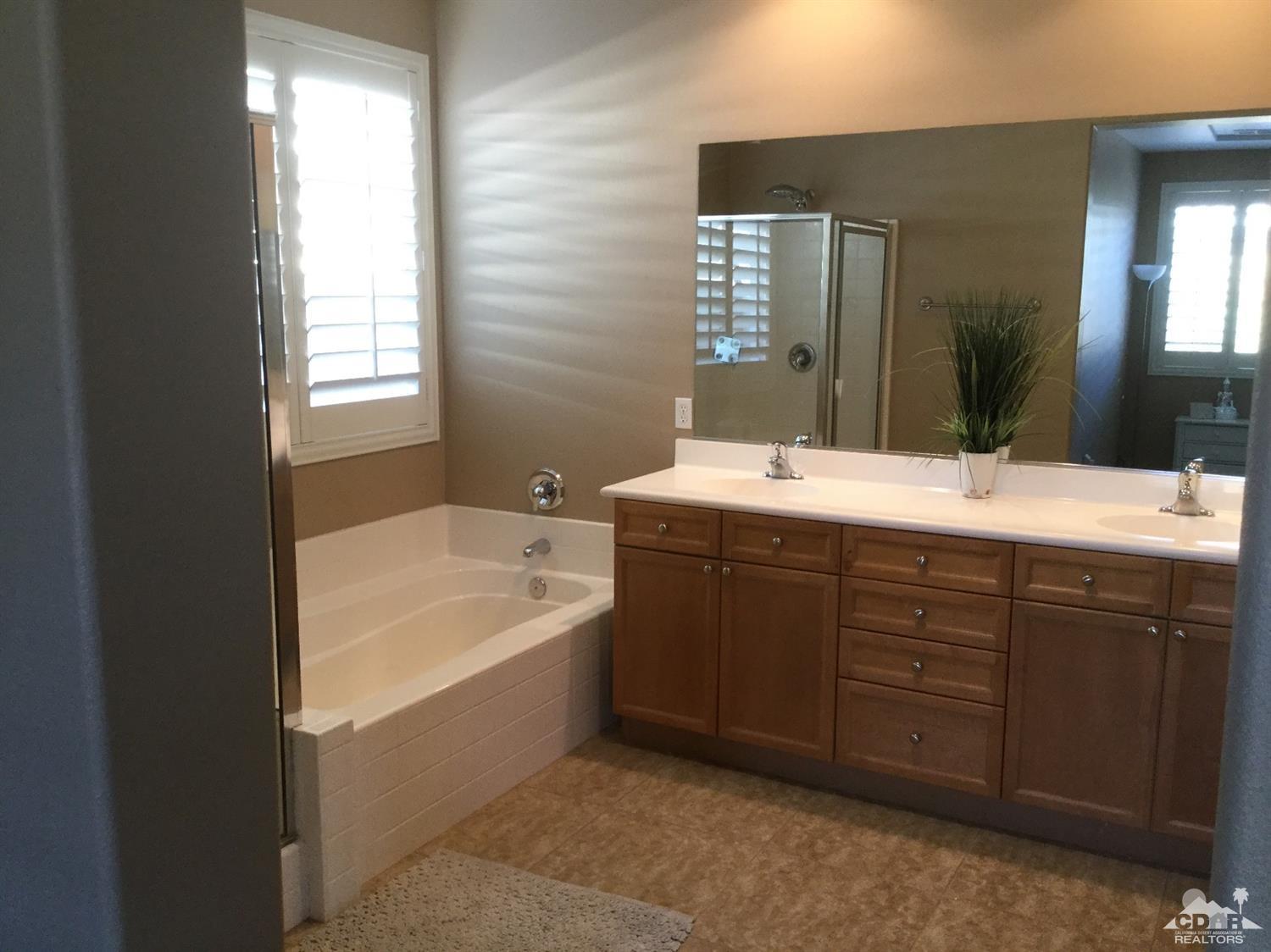 83316 Lone Star Road Indio, CA 92203 - Photo 10 of 43 a bathroom with a tub a sink double vanity and a mirror