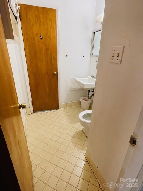 1421 Tyvola Road Charlotte, NC 28210 - Photo 12 of 23 a bathroom with a sink and a toilet
