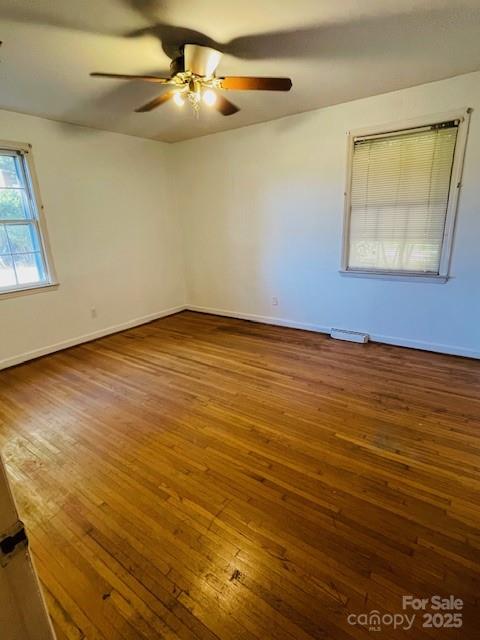 1421 Tyvola Road Charlotte, NC 28210 - Photo 15 of 23 a view of an empty room with window and wooden floor