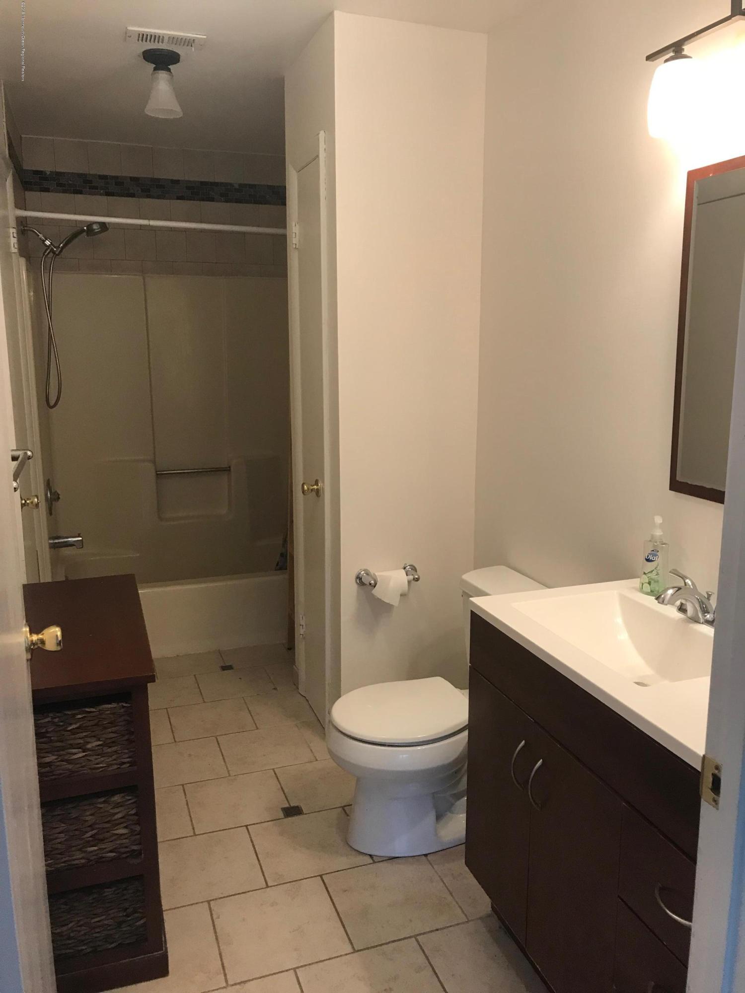 509 Harding Road, Unit 6 Freehold, NJ 07728 - Photo 12 of 15 a bathroom with a sink a toilet and shower