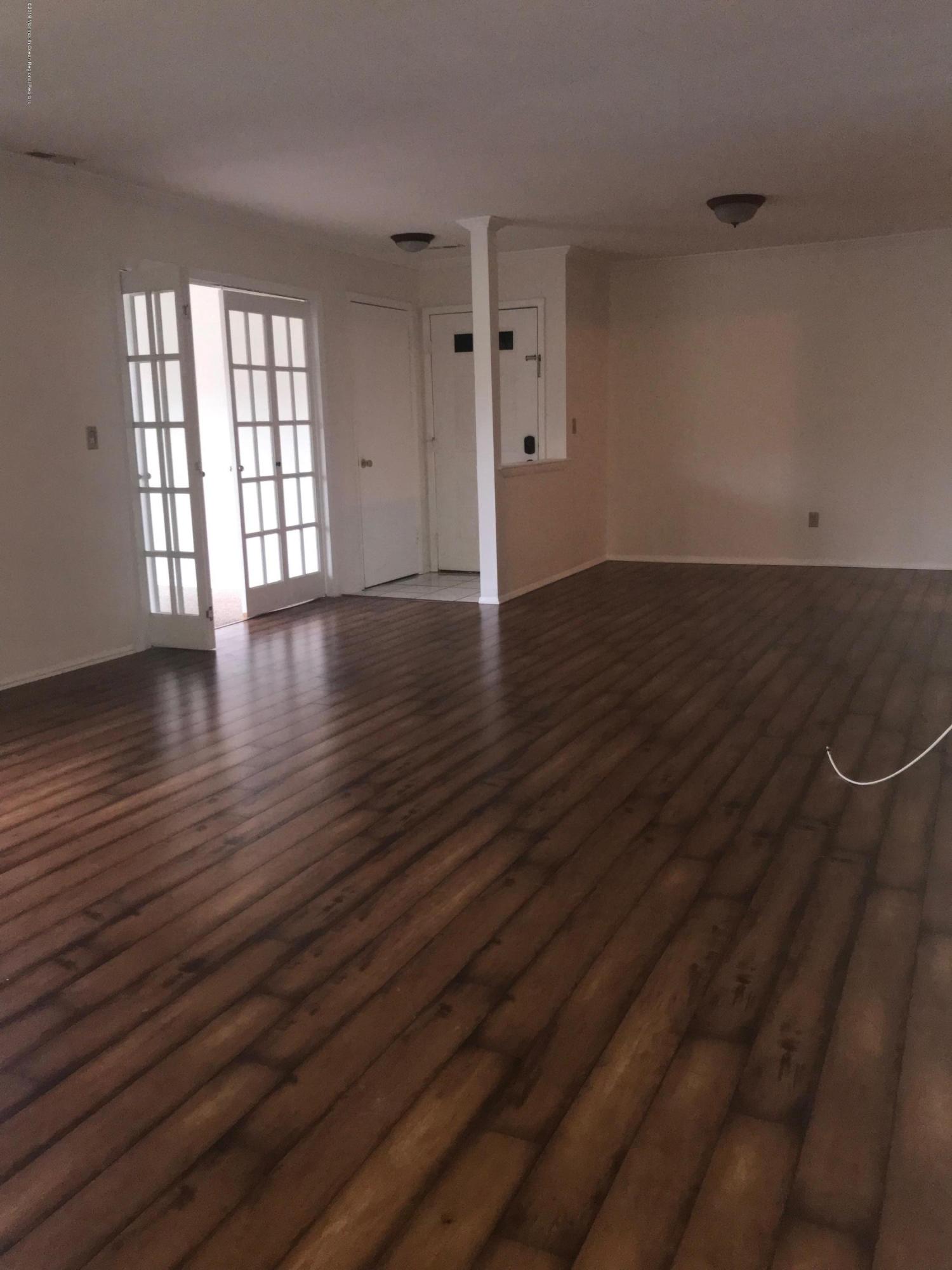509 Harding Road, Unit 6 Freehold, NJ 07728 - Photo 2 of 15 an empty room with wooden floor and windows