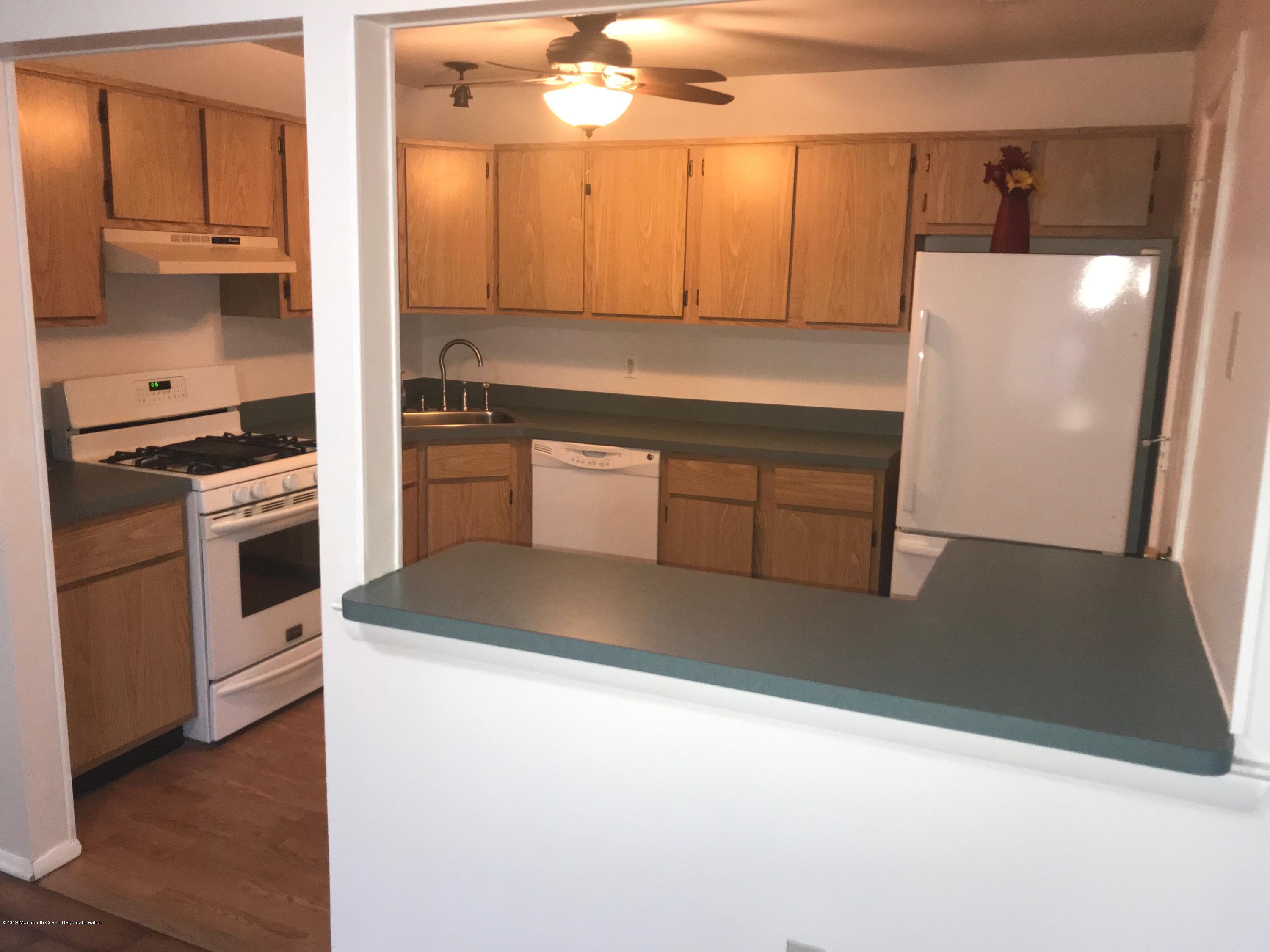 509 Harding Road, Unit 6 Freehold, NJ 07728 - Photo 6 of 15 a kitchen with a sink a stove and cabinets
