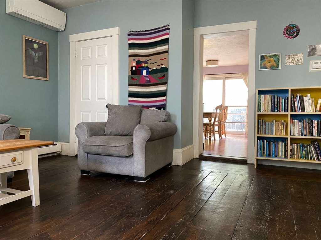 8 May Street Beverly, MA 01915 - Photo 6 of 25 a living room with furniture and a book shelf