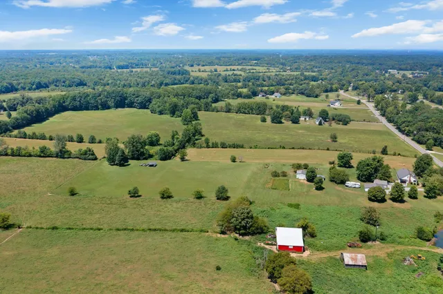 an aerial view of a houses with a yard