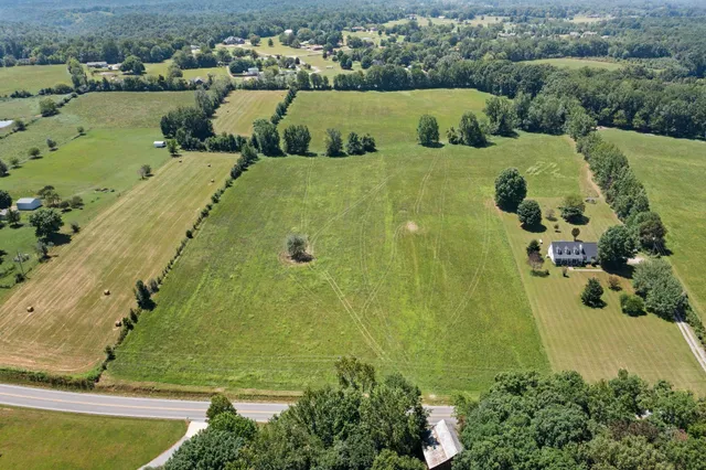 an aerial view of a residential houses with outdoor space