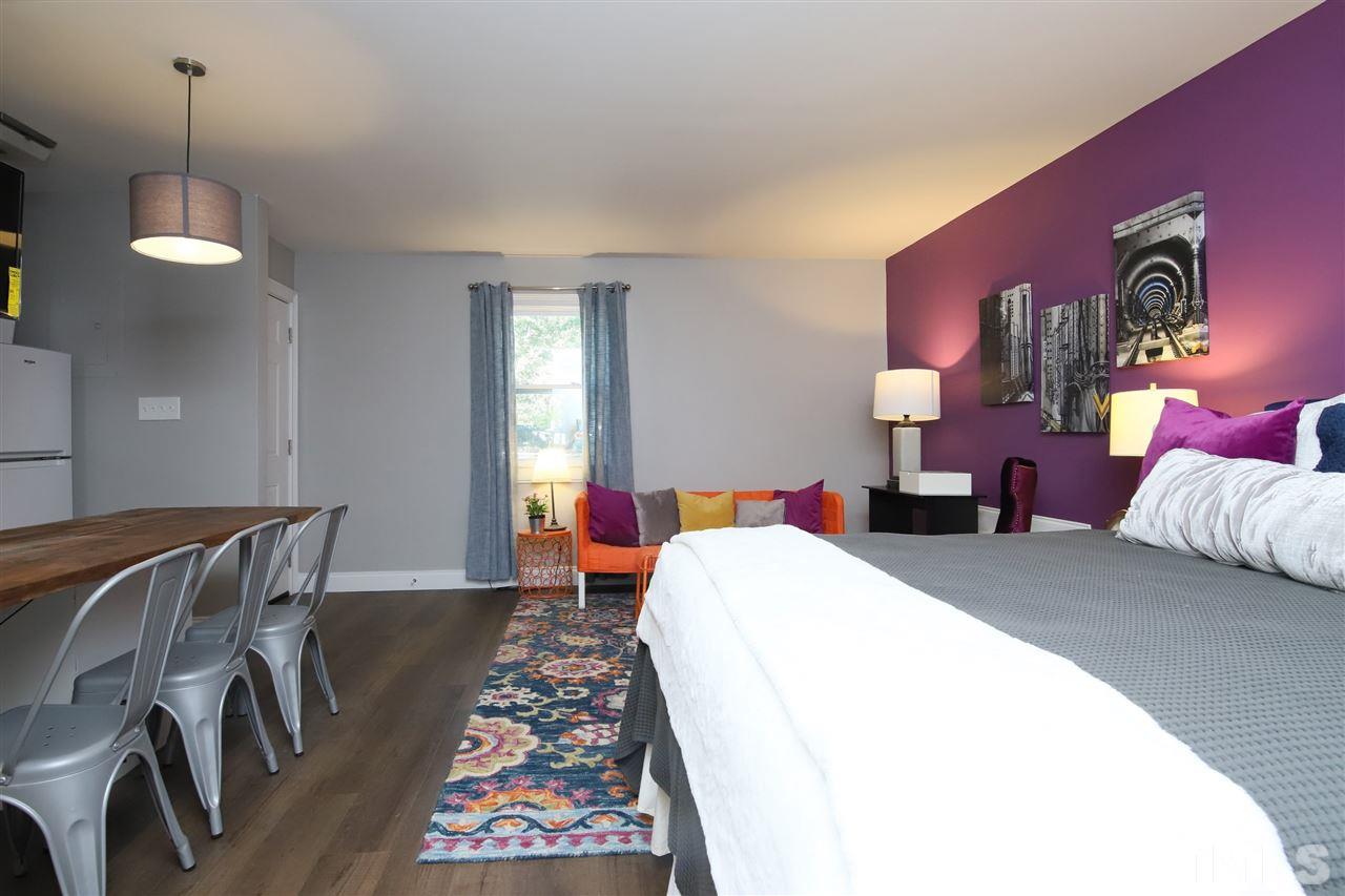 815 Clay Street Raleigh, NC 27605 - Photo 13 of 30 a bed room with a bed and a chair