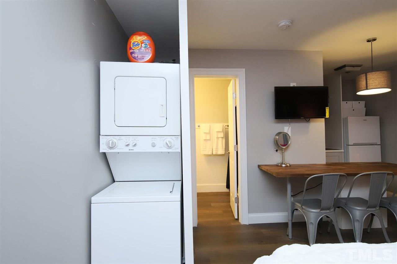 815 Clay Street Raleigh, NC 27605 - Photo 17 of 30 a living room with furniture a flat screen tv and kitchen view