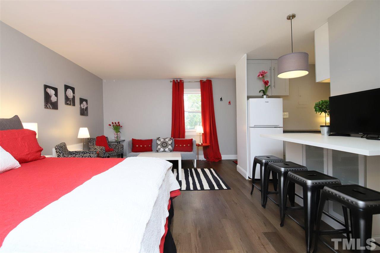 815 Clay Street Raleigh, NC 27605 - Photo 19 of 30 a bedroom with a bed and a chandelier