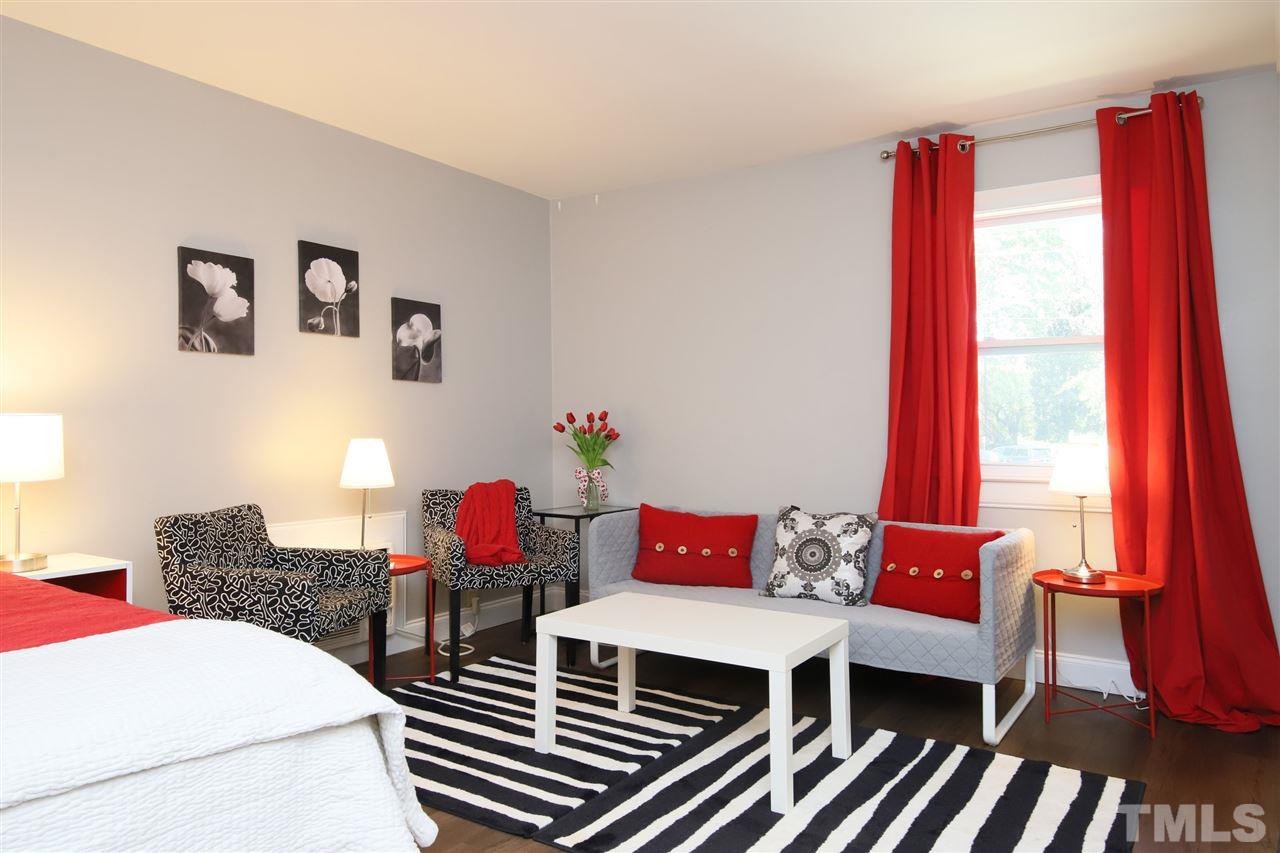 815 Clay Street Raleigh, NC 27605 - Photo 20 of 30 a living room with furniture a wooden floor and a large window