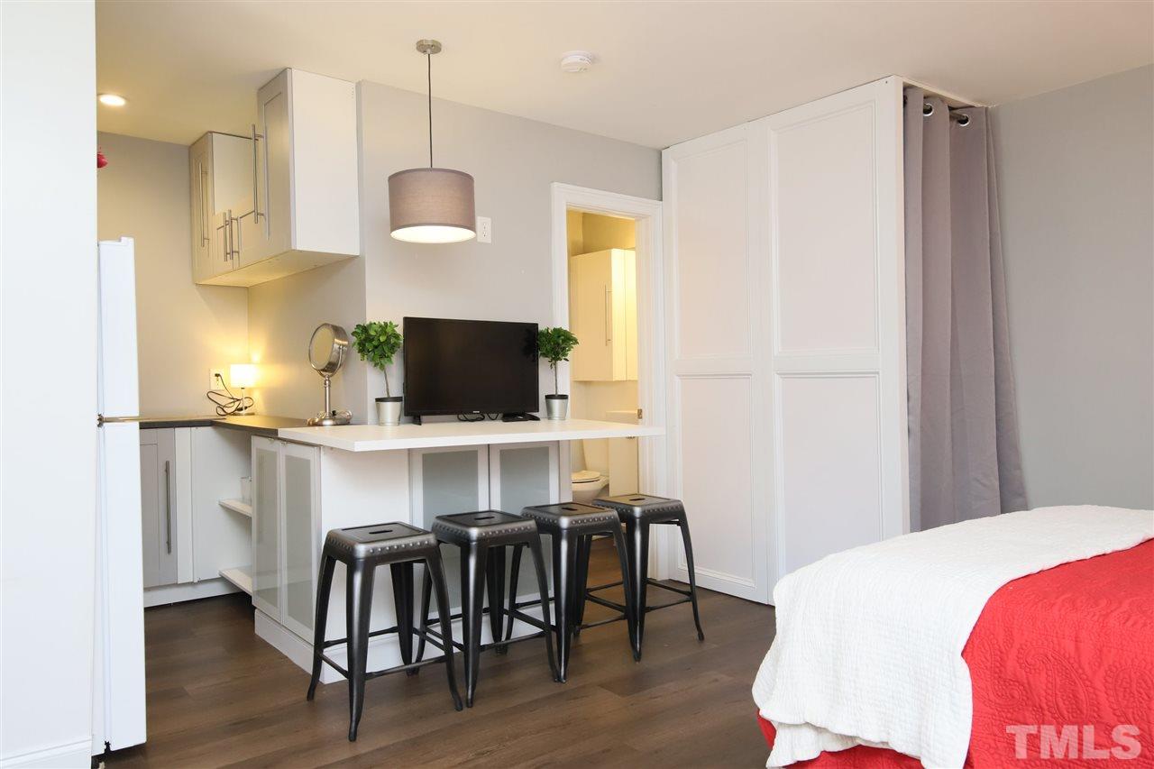 815 Clay Street Raleigh, NC 27605 - Photo 21 of 30 a bedroom with a bed and a flat screen tv