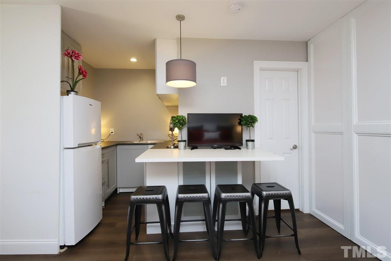 815 Clay Street Raleigh, NC 27605 - Photo 22 of 30 a view of kitchen with cabinets stainless steel appliances and a chandelier