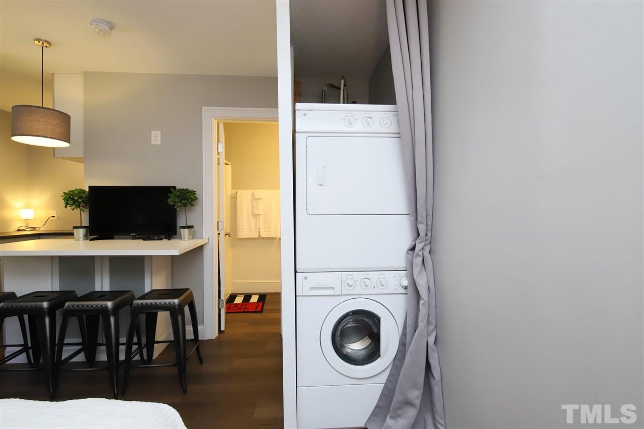 815 Clay Street Raleigh, NC 27605 - Photo 24 of 30 a living room with a couch and a flat screen tv