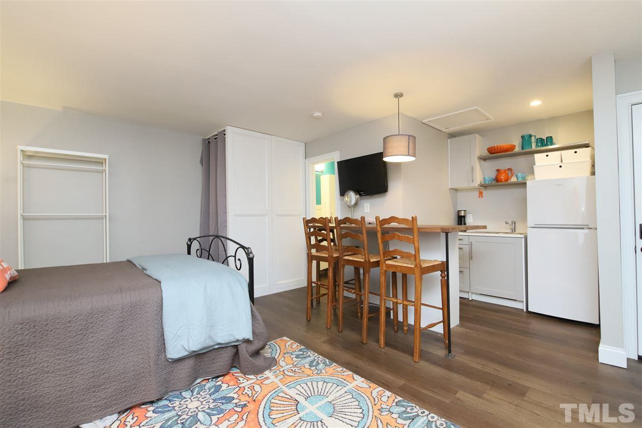 815 Clay Street Raleigh, NC 27605 - Photo 27 of 30 a workspace with furniture wooden floor and a rug